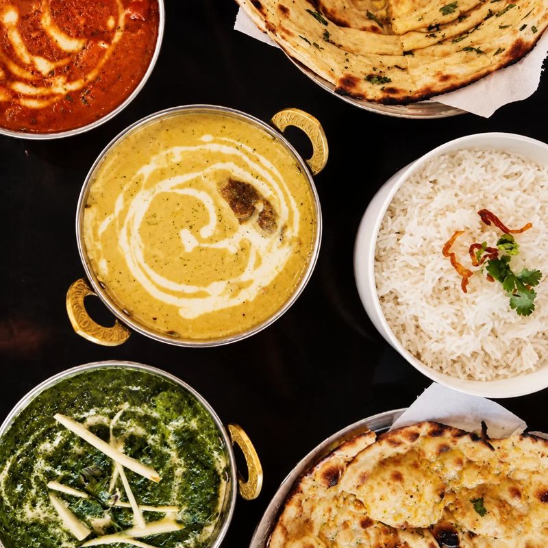 A selection of Gate of India curries with rice and bread