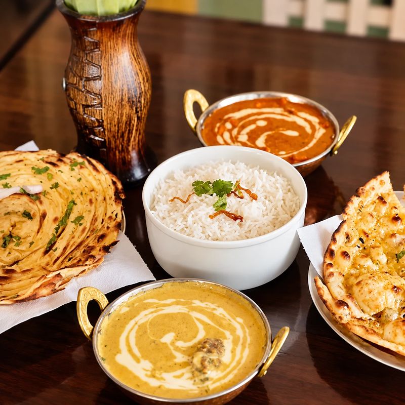 Gate of India curry, rice and fresh bread ready to share